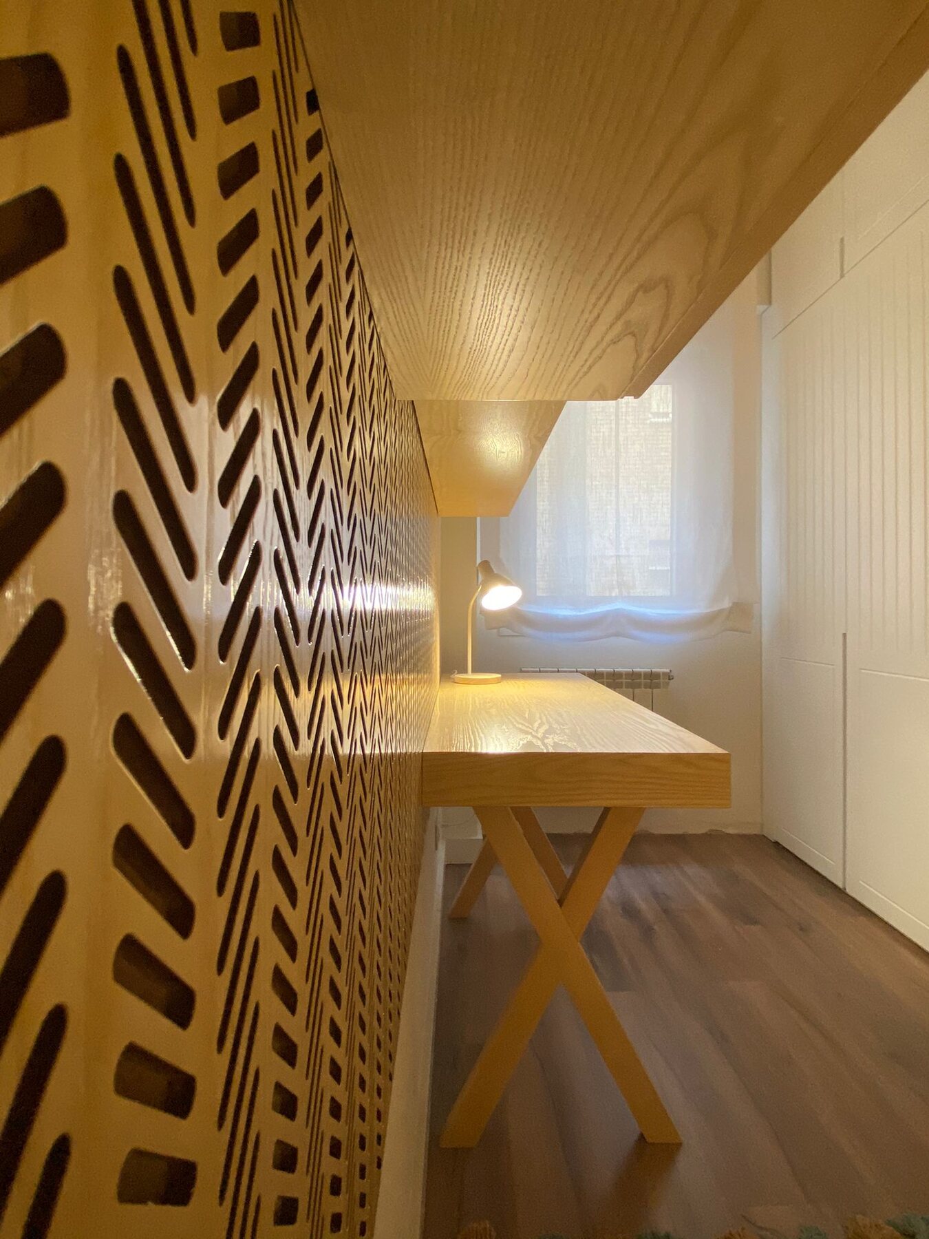 Pasillo de vivienda en Madrid con revestimiento de listones de madera